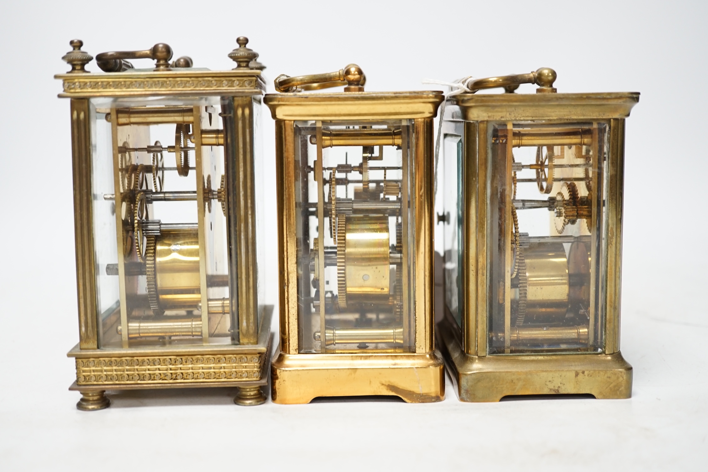 Three carriage timepieces with enamel dials, largest 14.5cm high. Condition - poor to fair